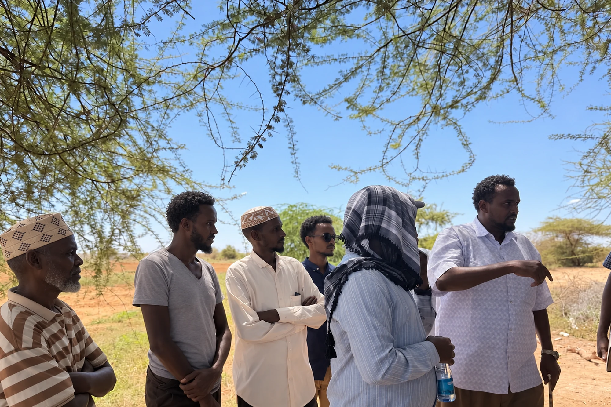 A field team meeting farmers outdoors