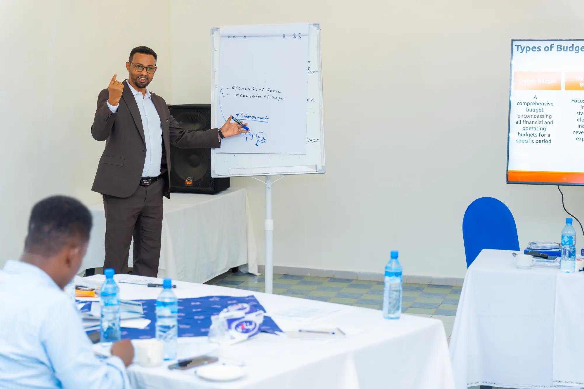 A facilitator explaining material on a flip chart