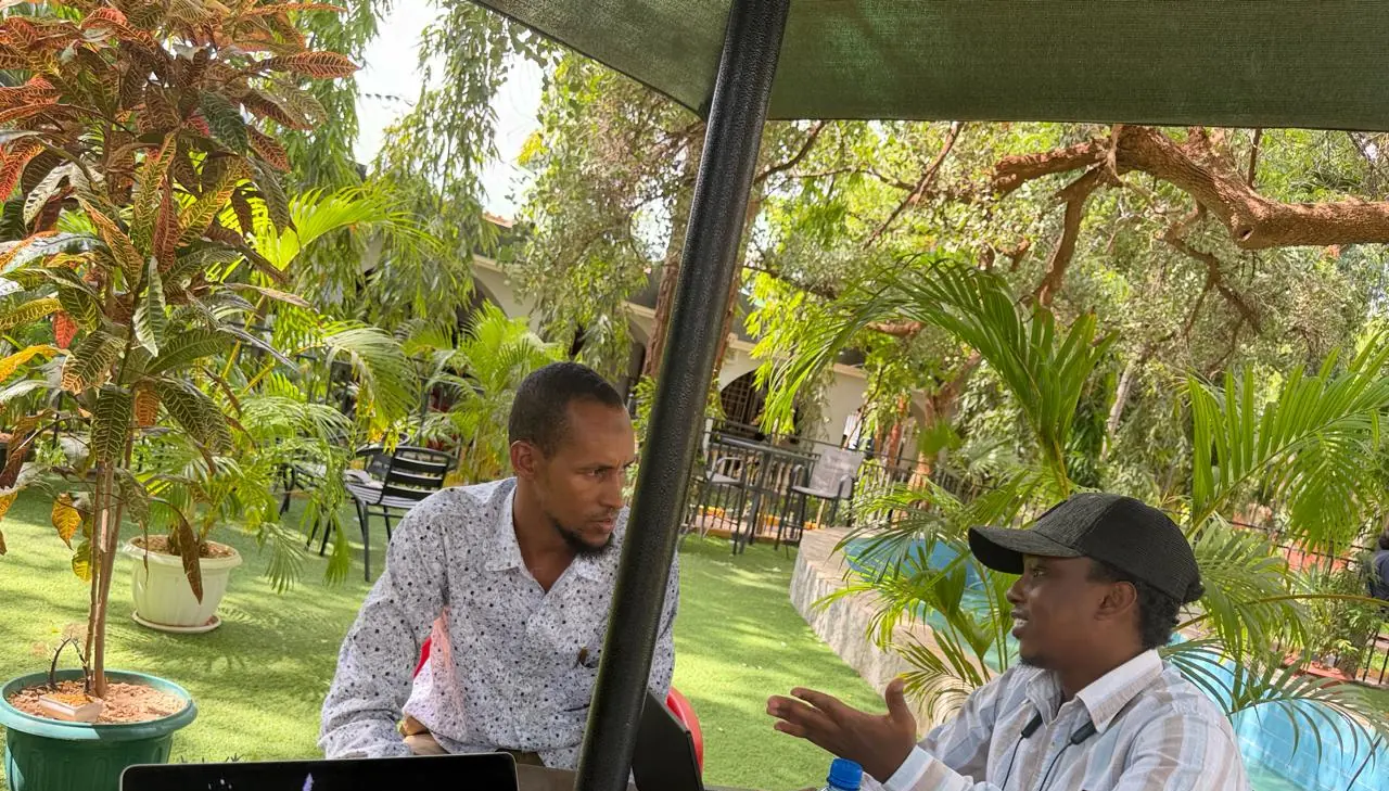 A researcher interviewing a local official